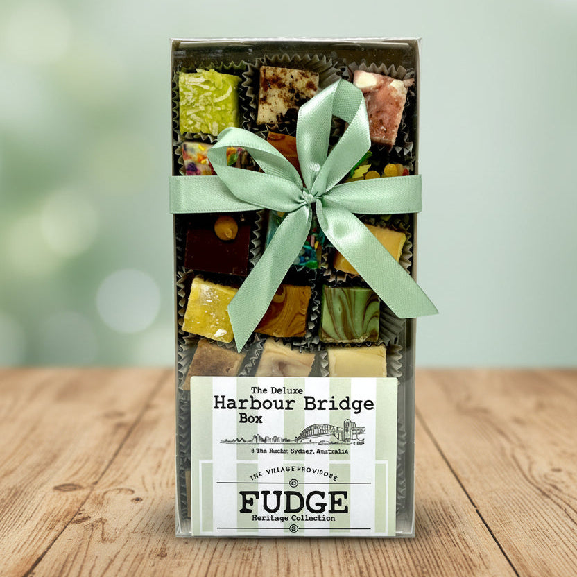 Box of fudge with a green ribbon on a white background